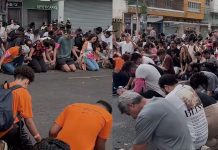 Jóvenes cristianos oran de rodillas en medio del Carnaval de Belo Horizonte